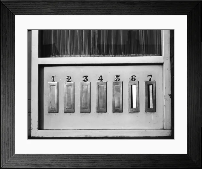 Framed Print : Seven identical letter boxes in a block of flats. Date: 1960s Framed Print : Seven identical letter boxes in a block of flats. Date: 1960s