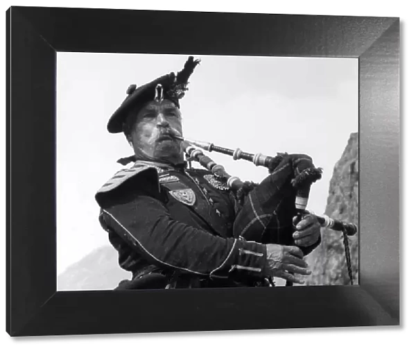 Study of Highland Piper, playing his bagpipes, Scotland. Date: 1950s