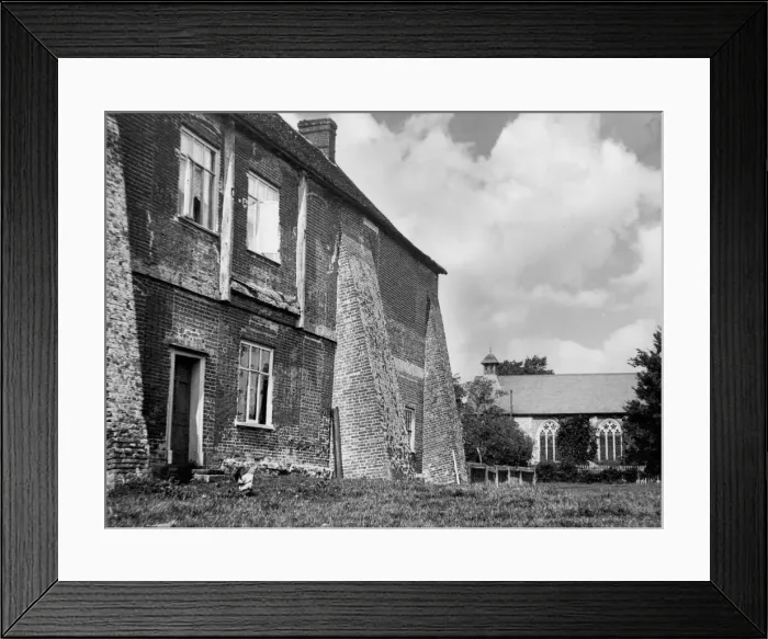 Framed Print : These massive buttresses now adjoining a house, were once part of Wix Abbey, Essex Framed Print : These massive buttresses now adjoining a house, were once part of Wix Abbey, Essex
