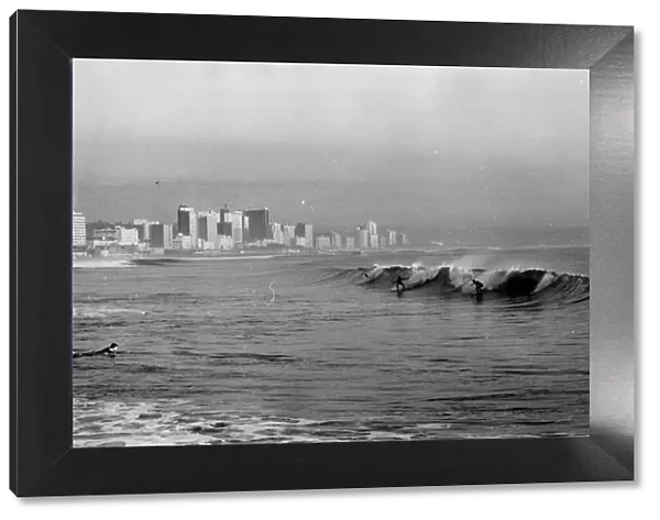 Surfing at Durban, South Africa. Date: late 1960s