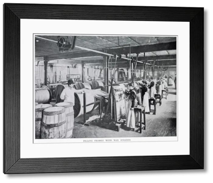 Framed Print : Women working in a large factory making wax candles with a foreman standing watching them Framed Print : Women working in a large factory making wax candles with a foreman standing watching them