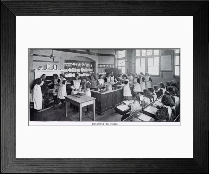 Framed Print : Girls in a cookery lesson, learning to cook tarts and a joint of beef which a group of Framed Print : Girls in a cookery lesson, learning to cook tarts and a joint of beef which a group of