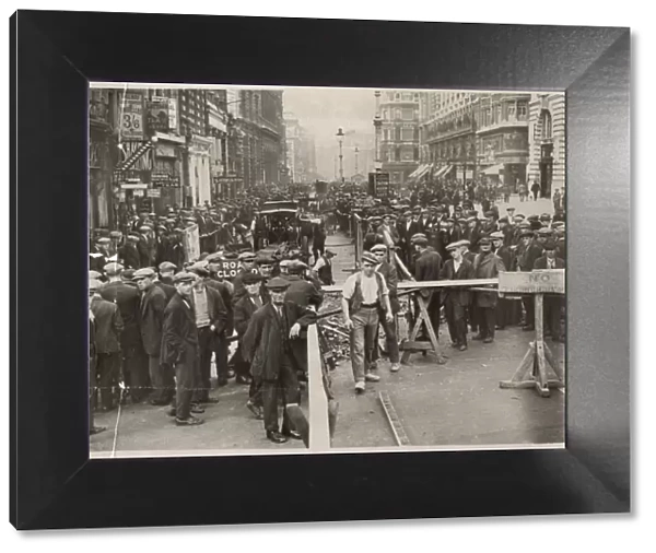 Disruption in Piccadilly, London, with crowds of people watching work being done on part