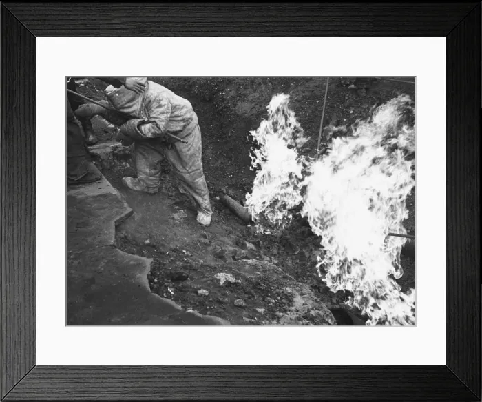 Framed Print : In the bombing aftermath of World War II, the debris is cleared away by men in asbestos Framed Print : In the bombing aftermath of World War II, the debris is cleared away by men in asbestos
