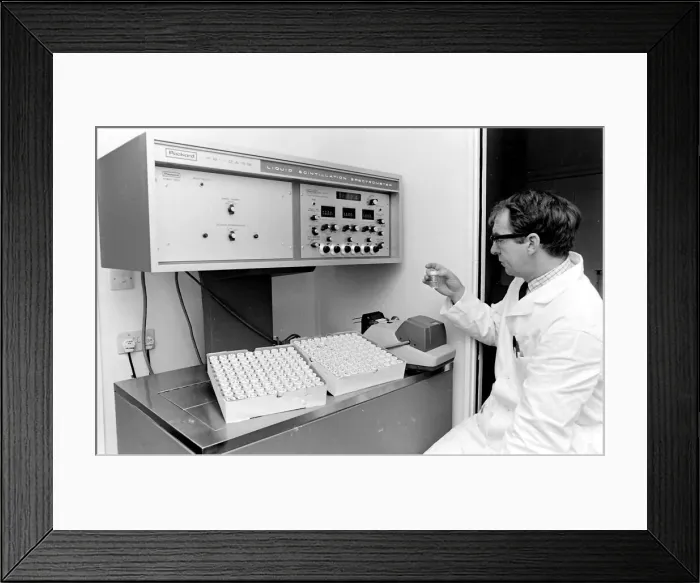Framed Print : Horse doping tests -- a laboratory technician in a white coat sits in front of a Packard Framed Print : Horse doping tests -- a laboratory technician in a white coat sits in front of a Packard