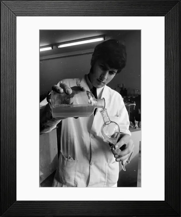 Framed Print : Horse doping tests -- a laboratory technician in a white coat pours a sample from a large Framed Print : Horse doping tests -- a laboratory technician in a white coat pours a sample from a large