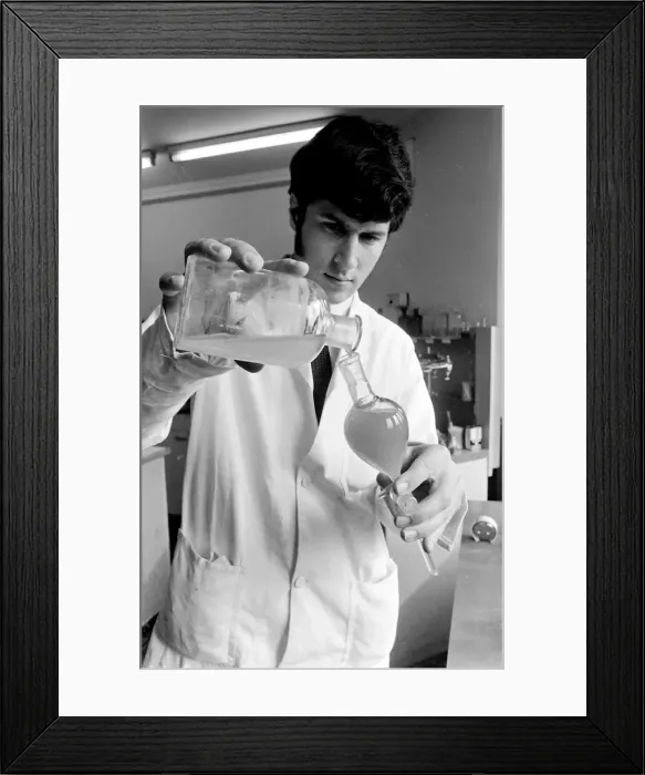 Framed Print : Horse doping tests -- a laboratory technician in a white coat pours a sample from a large Framed Print : Horse doping tests -- a laboratory technician in a white coat pours a sample from a large