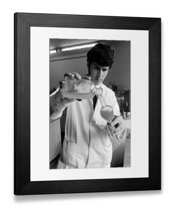 Framed Print : Horse doping tests -- a laboratory technician in a white coat pours a sample from a large Framed Print : Horse doping tests -- a laboratory technician in a white coat pours a sample from a large