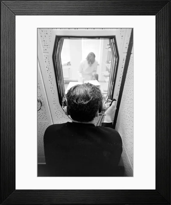 Framed Print : Biomedical centre, London -- a patient in a locked room listens to something through Framed Print : Biomedical centre, London -- a patient in a locked room listens to something through