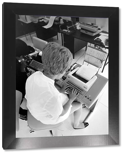 Biomedical centre, London -- a woman in an office operates a telex machine