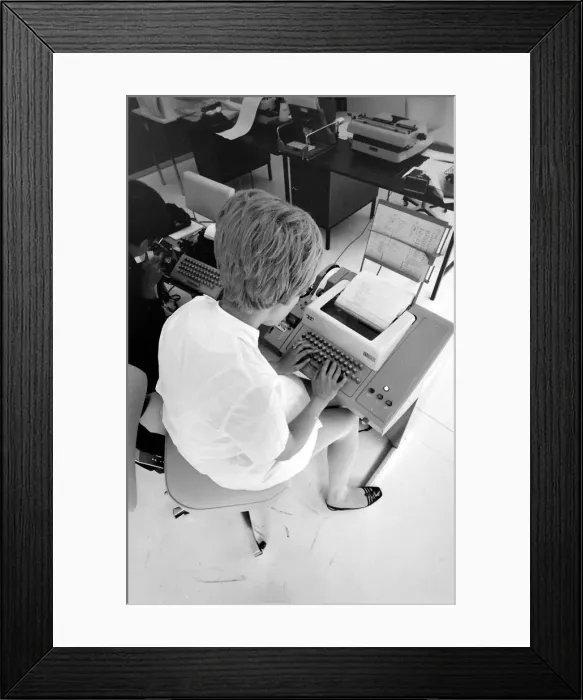 Framed Print : Biomedical centre, London -- a woman in an office operates a telex machine Framed Print : Biomedical centre, London -- a woman in an office operates a telex machine