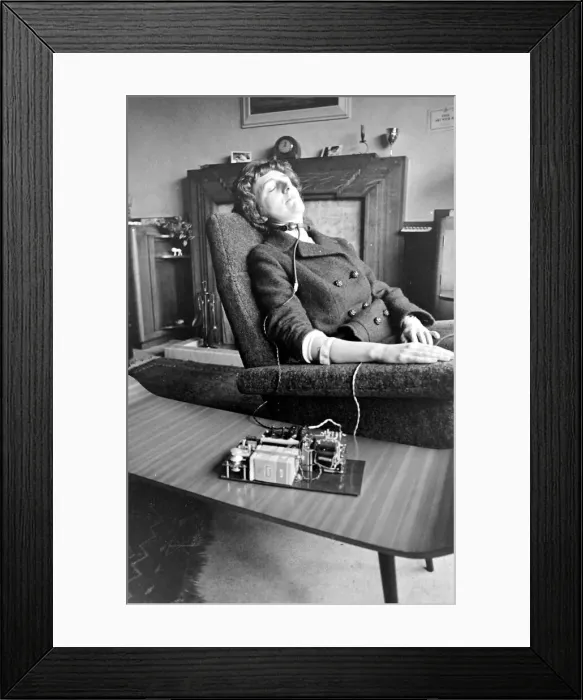 Framed Print : Woman asleep in an armchair with an anti-snoring machine attached to her Framed Print : Woman asleep in an armchair with an anti-snoring machine attached to her