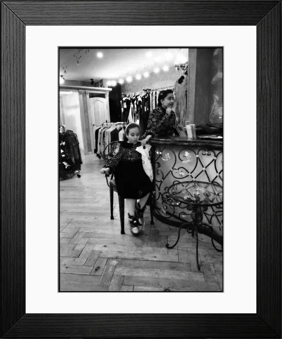 Framed Print : Child and assistant interior Egyptian clothing store, Egypt. Date: 1980s Framed Print : Child and assistant interior Egyptian clothing store, Egypt. Date: 1980s