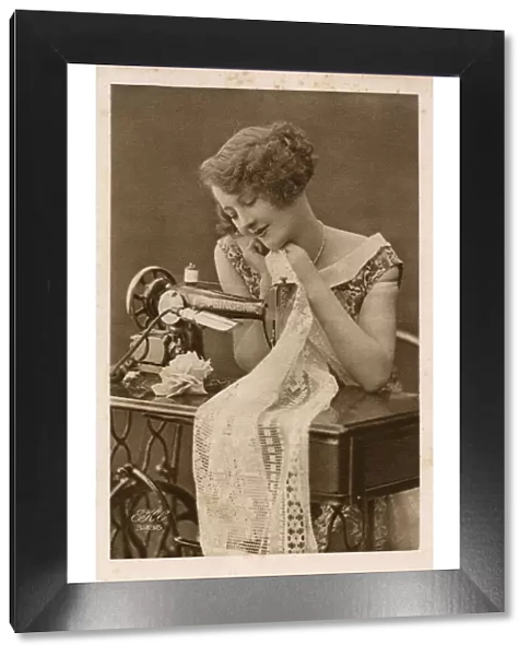 Young woman using a Singer Sewing Machine