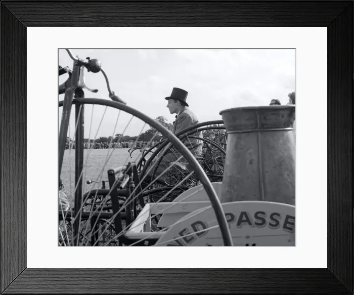 Framed Print : Top Hat. Man wearing a top hat Penny Farthing in the foreground at Country Framed Print : Top Hat. Man wearing a top hat Penny Farthing in the foreground at Country