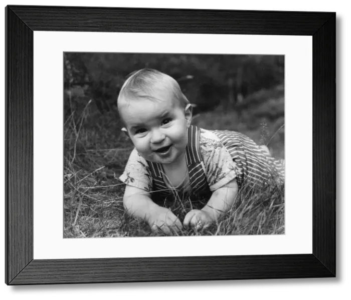 Framed Print : Toddler playing in a garden Framed Print : Toddler playing in a garden