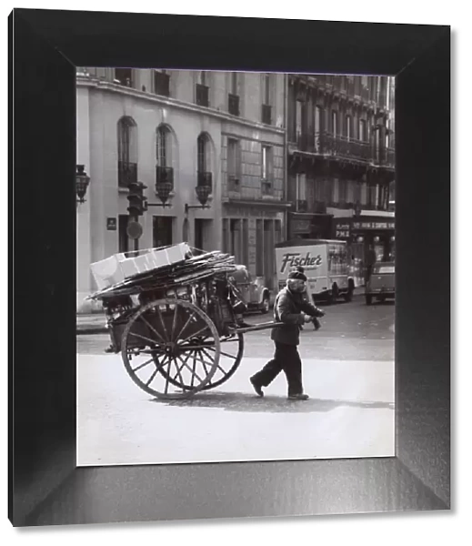 Man pulling a loaded cart, Paris, France