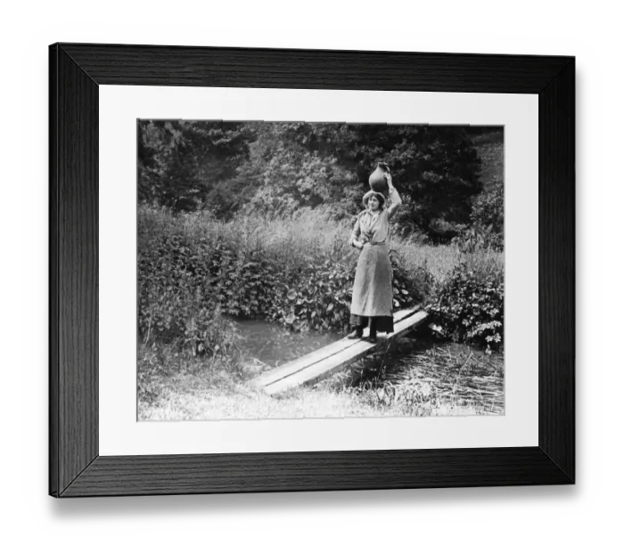 Framed Print : Countrywoman carrying a pot over a bridge, 1890s