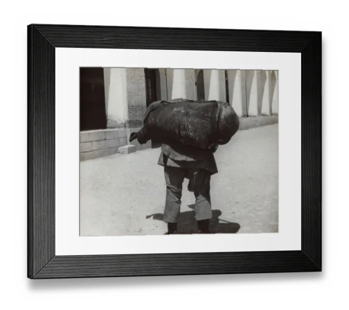Framed Print : Man carrying a heavy weight Framed Print : Man carrying a heavy weight