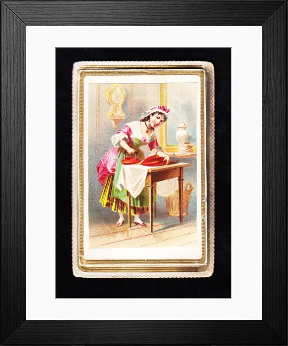 Framed Print : Woman using a heart-shaped iron on a Valentine card Framed Print : Woman using a heart-shaped iron on a Valentine card