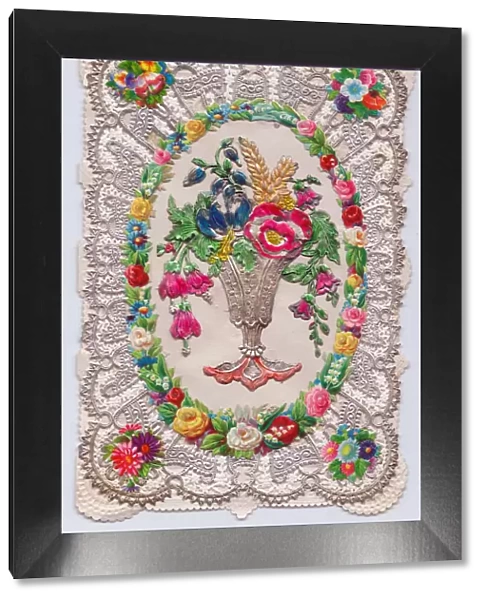 Vase of flowers on a paper lace greetings card
