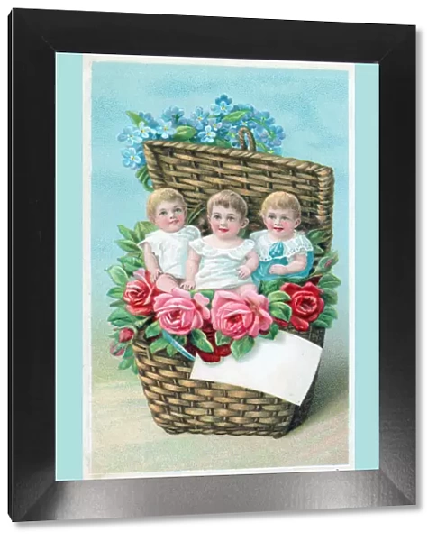 Children in a basket of flowers on a greetings postcard