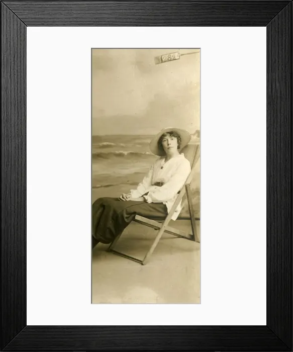 Framed Print : Young woman in a deckchair in a studio photo Framed Print : Young woman in a deckchair in a studio photo