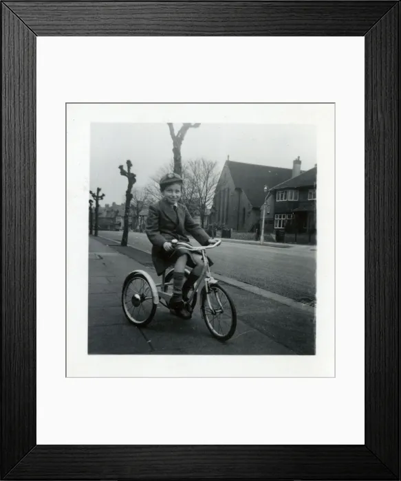 Framed Print : Little boy on a tricycle in a suburban street