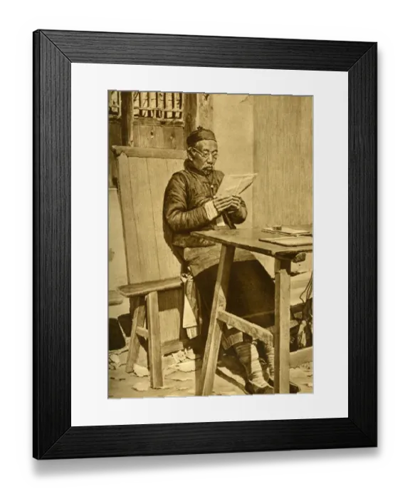 Framed Print : Elderly man reading at a table, Shanghai, China, East Asia Framed Print : Elderly man reading at a table, Shanghai, China, East Asia