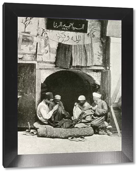 Arab tailor and assistants at work in a shop, Cairo, Egypt