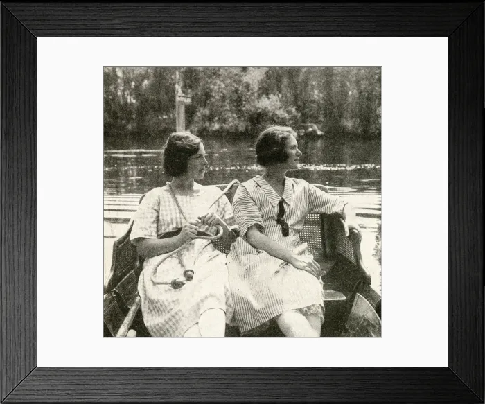 Framed Print : Two young women steering a barge on a river, England Framed Print : Two young women steering a barge on a river, England