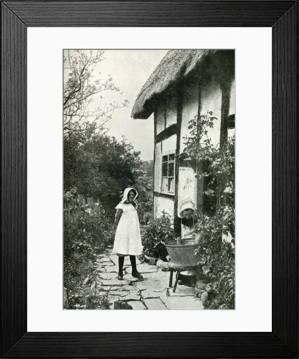 Framed Print : Mother and daughter outside a thatched cottage, England Framed Print : Mother and daughter outside a thatched cottage, England