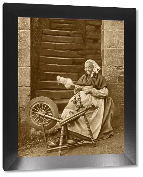 Woman at a spinning wheel, Dinan, Brittany, Northern France