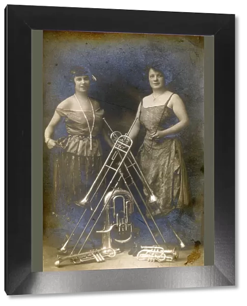 Two Lady Brass Musicians and a variety of their instruments