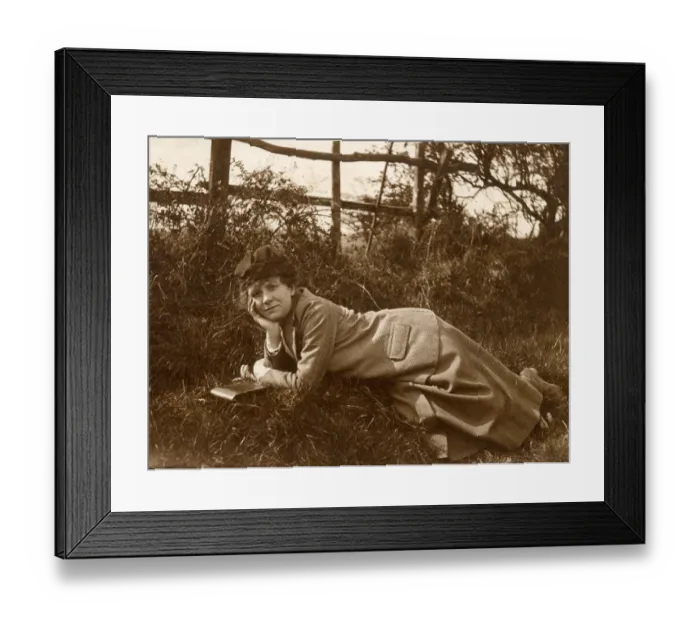 Framed Print : Woman lying on grass in a field Framed Print : Woman lying on grass in a field