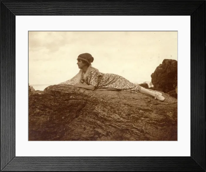 Framed Print : Woman lying on a rock at the seaside Framed Print : Woman lying on a rock at the seaside