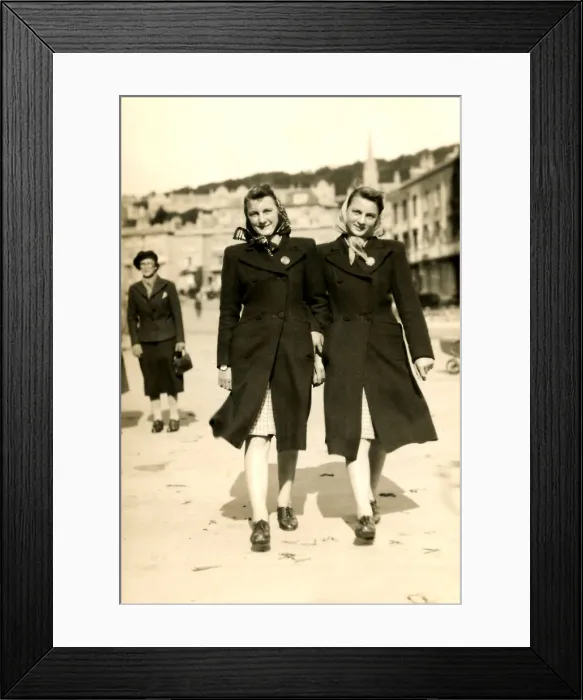 Framed Print : Twin sisters in matching headscarves, coats and skirts Framed Print : Twin sisters in matching headscarves, coats and skirts