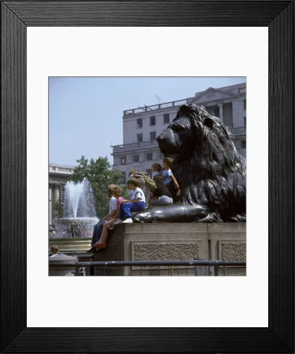 Framed Print : Children and adults sit on a Landseer Lion, Trafalgar Square Framed Print : Children and adults sit on a Landseer Lion, Trafalgar Square