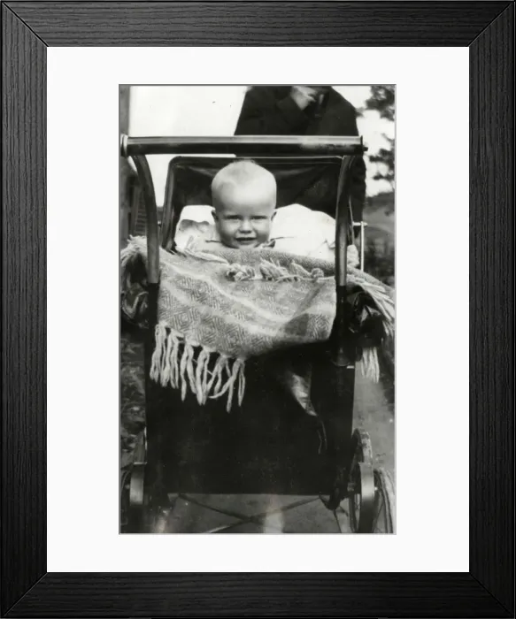 Framed Print : A Baby smiling out from a large Perambulator Framed Print : A Baby smiling out from a large Perambulator