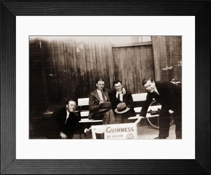 Framed Print : Four smiling men with Guinness advert Framed Print : Four smiling men with Guinness advert