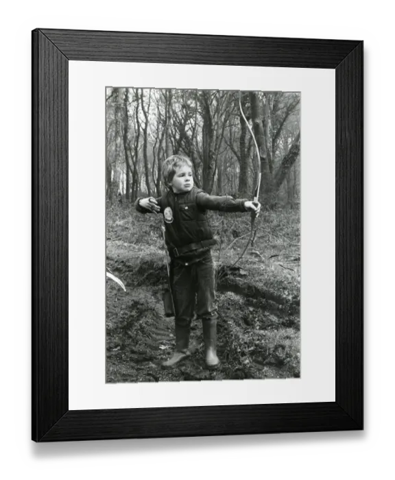 Framed Print : Boy practising archery in a wood Framed Print : Boy practising archery in a wood
