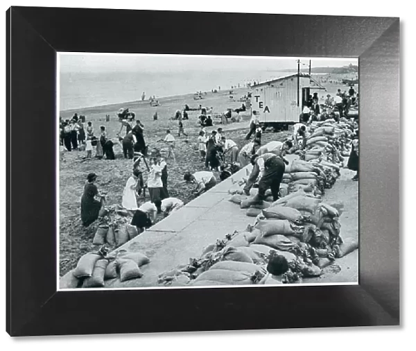 WWII September 1939 Holiday makers filling sandbags