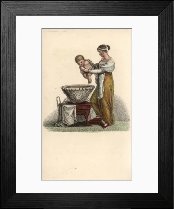 Framed Print : Mother putting her baby into a bath Framed Print : Mother putting her baby into a bath