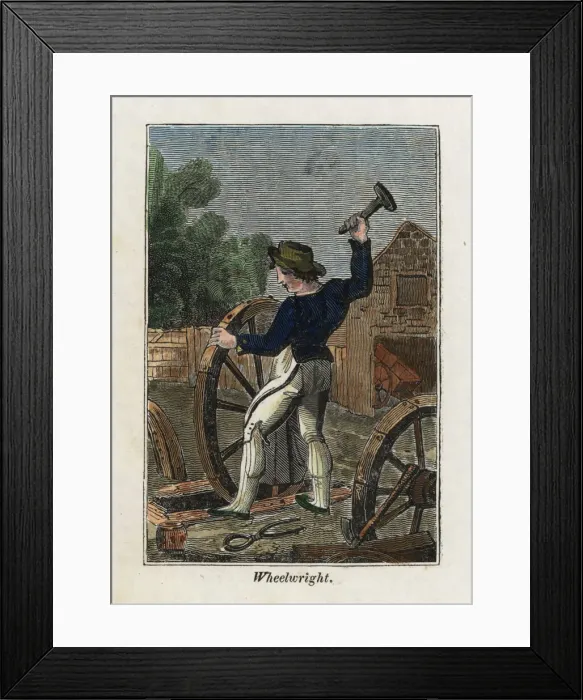 Framed Print : Wheelwright hammering a metal cover onto a Framed Print : Wheelwright hammering a metal cover onto a