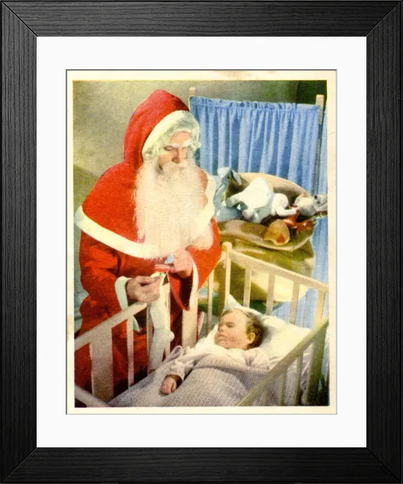 Framed Print : Christmas card, Santa Claus visiting baby in cot Framed Print : Christmas card, Santa Claus visiting baby in cot