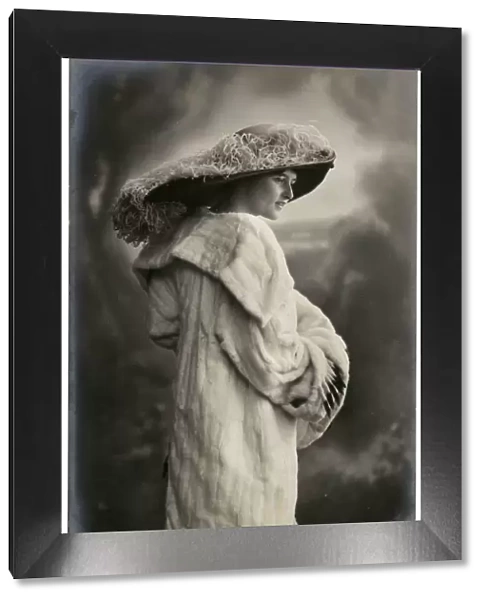 Young Edwardian woman in large hat and mink coat