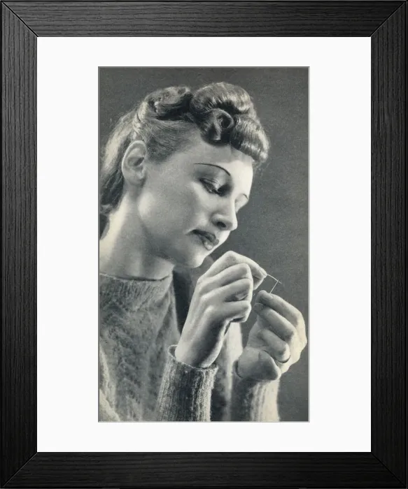 Framed Print : Woman threading a needle Framed Print : Woman threading a needle