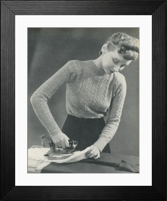 Framed Print : Woman pressing a seam under a damp cloth Framed Print : Woman pressing a seam under a damp cloth