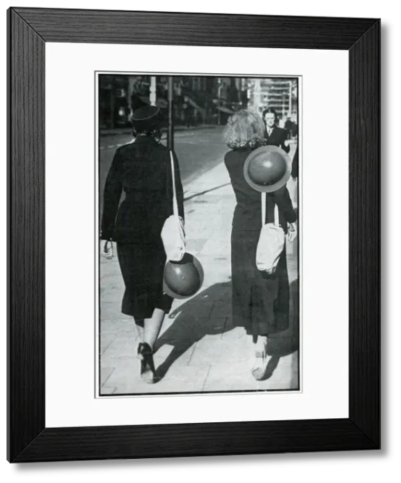 Framed Print : Backs of two walking girls holding helmets, September 1939 Framed Print : Backs of two walking girls holding helmets, September 1939