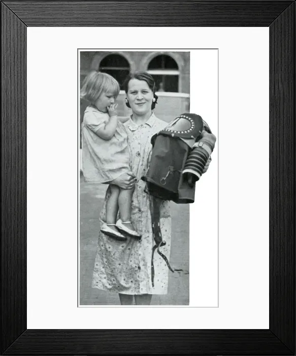 Framed Print : Mother holding baby and specialised gas mask, Sept 1939 Framed Print : Mother holding baby and specialised gas mask, Sept 1939